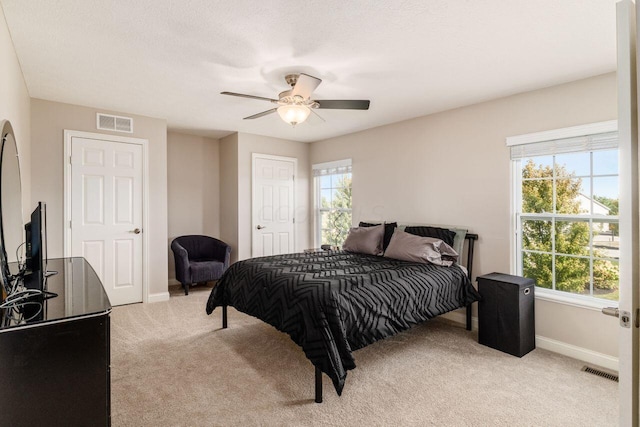 carpeted bedroom featuring ceiling fan