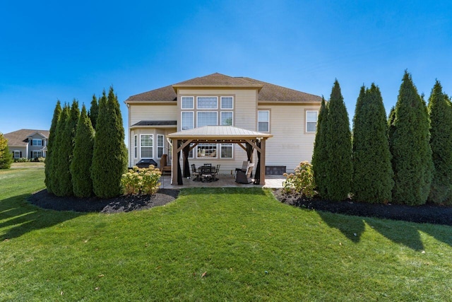 rear view of property with a gazebo, a yard, and a patio