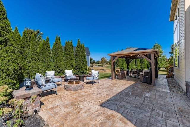 view of patio featuring a gazebo and an outdoor living space with a fire pit