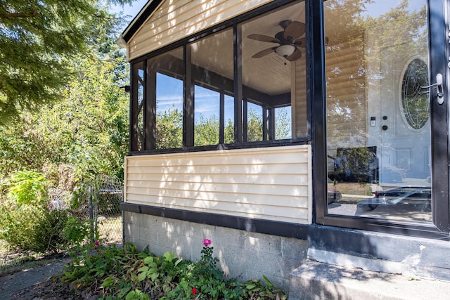 exterior space with ceiling fan