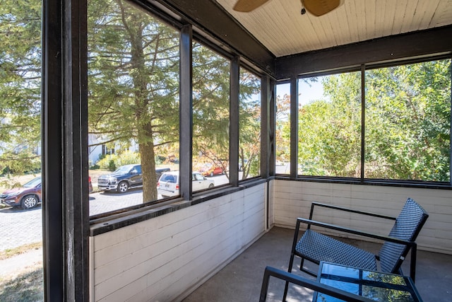 unfurnished sunroom featuring ceiling fan