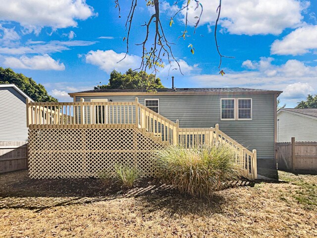 rear view of property featuring a deck