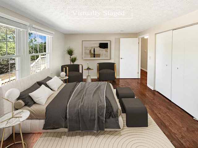 bedroom with hardwood / wood-style floors, a textured ceiling, and a closet