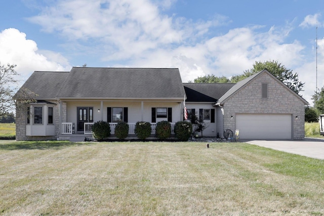 ranch-style home with covered porch, a front yard, and a garage