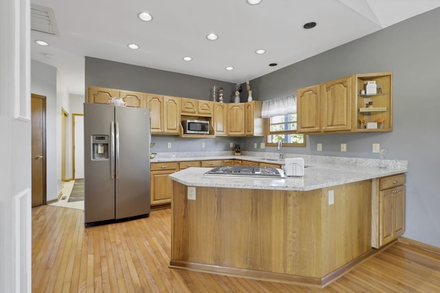 kitchen with sink, light hardwood / wood-style flooring, light stone counters, kitchen peninsula, and stainless steel appliances