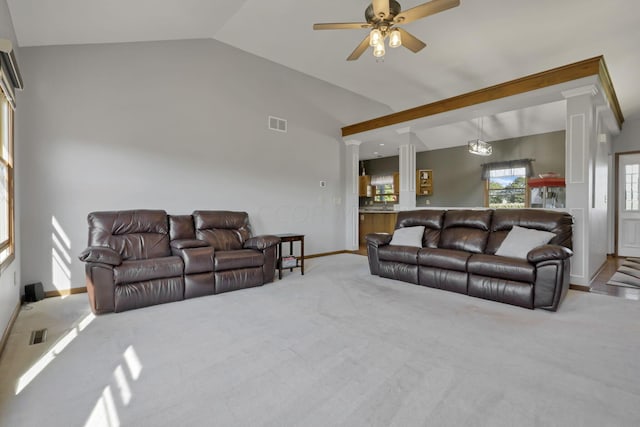 living room with lofted ceiling, ceiling fan, and carpet floors