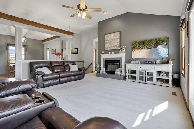 living room with ceiling fan, light colored carpet, decorative columns, and vaulted ceiling