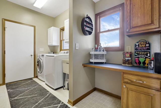 washroom featuring cabinets and independent washer and dryer