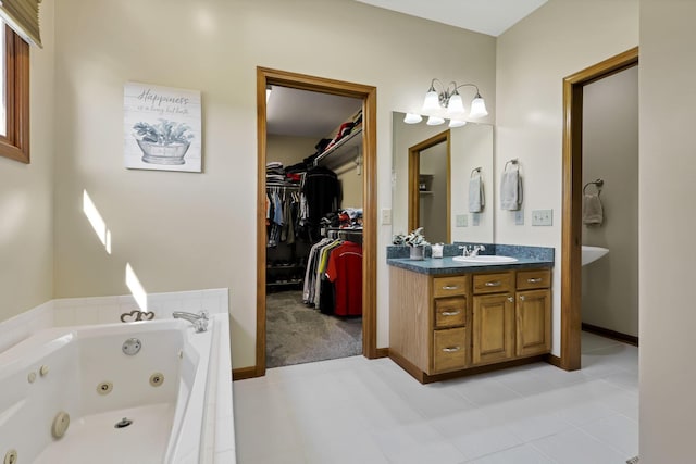 bathroom with tile patterned flooring, vanity, and tiled tub