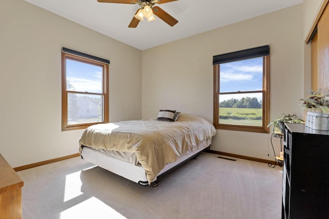 bedroom featuring light carpet and ceiling fan