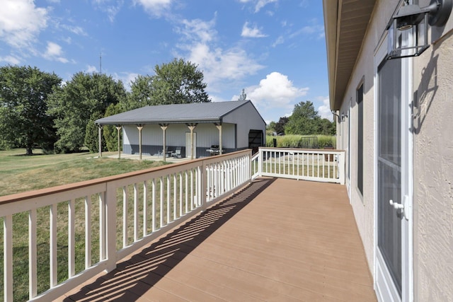 wooden deck featuring a lawn