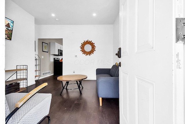 sitting room featuring dark hardwood / wood-style flooring