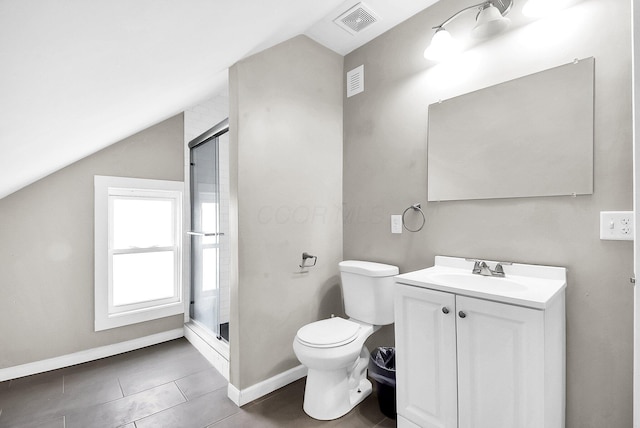 bathroom featuring vanity, a shower with door, vaulted ceiling, tile patterned flooring, and toilet