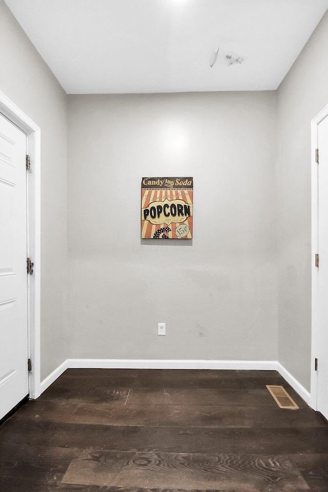 spare room with dark wood-type flooring