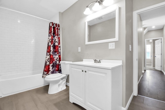 full bathroom with hardwood / wood-style flooring, vanity, shower / tub combo, and toilet