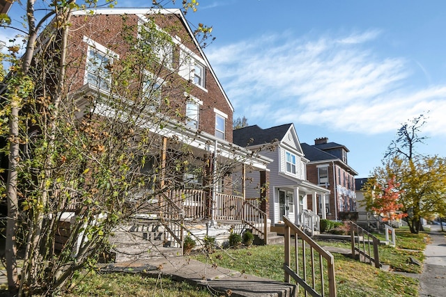 view of side of home with a porch