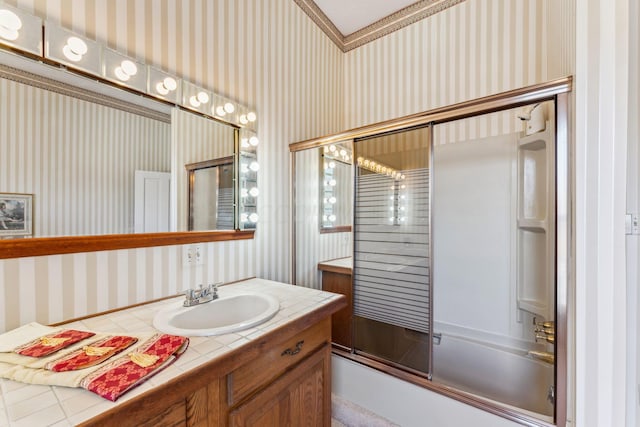 bathroom with vanity and bath / shower combo with glass door