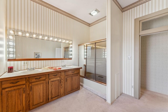 bathroom featuring vanity, combined bath / shower with glass door, and crown molding