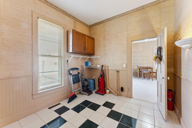 laundry area with wooden walls and light tile patterned floors