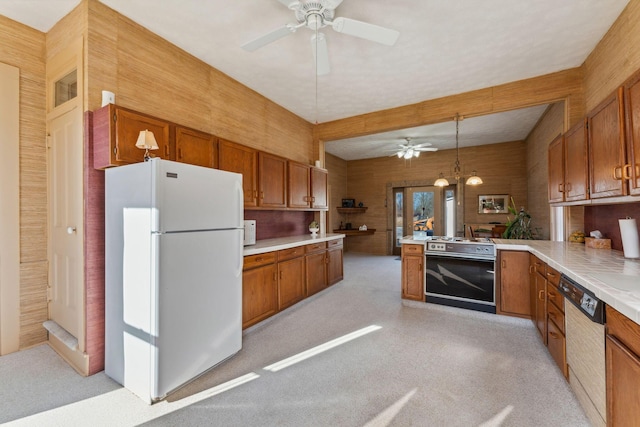 kitchen with range with electric cooktop, dishwasher, white refrigerator, kitchen peninsula, and pendant lighting