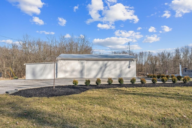 view of home's exterior featuring an outbuilding and a yard