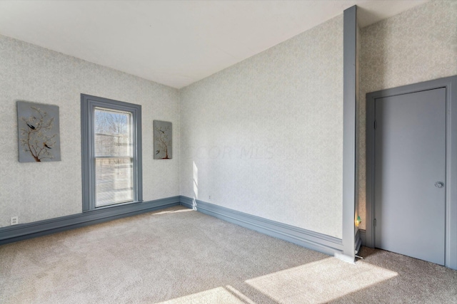 carpeted spare room featuring electric panel