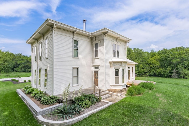 view of side of home with a yard