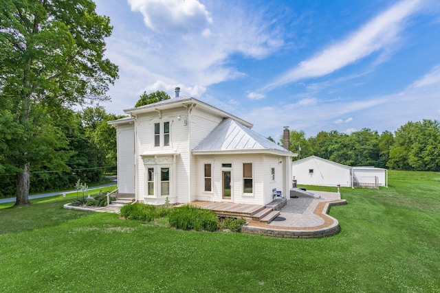 rear view of house featuring a yard