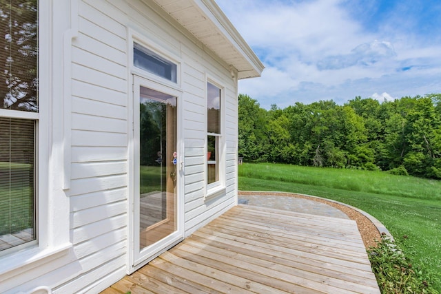 wooden terrace featuring a yard