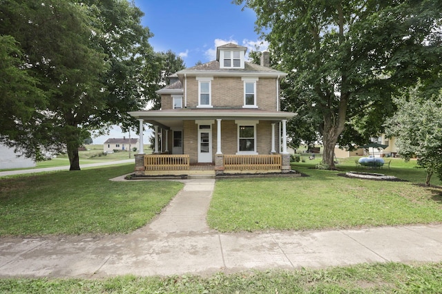 view of front of home with covered porch and a front yard