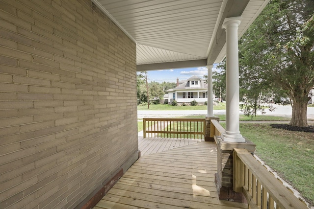 deck with a lawn and a porch