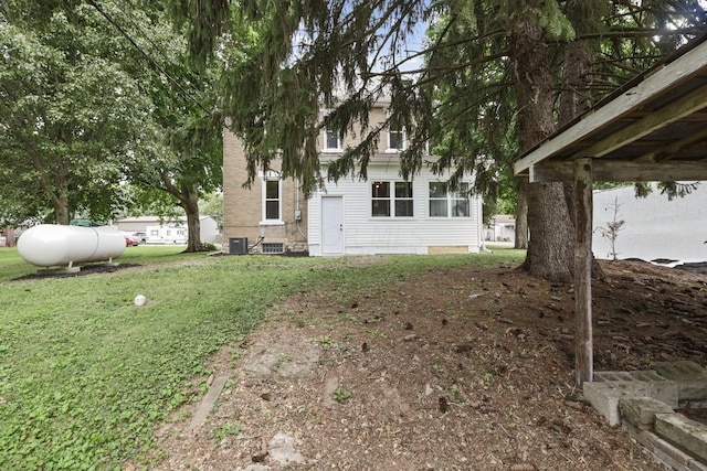 exterior space featuring central air condition unit and a front yard