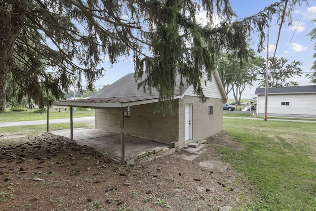 view of property exterior with a yard and a carport