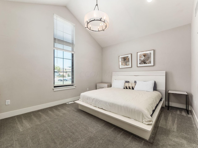 bedroom with dark carpet and vaulted ceiling