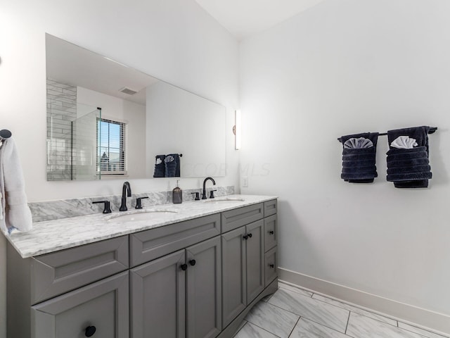 bathroom featuring a shower and vanity