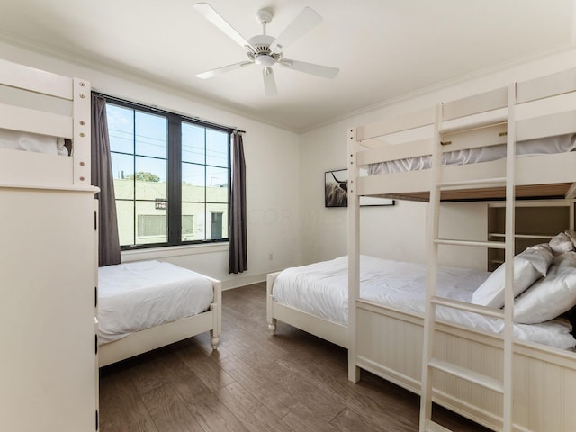 bedroom featuring dark hardwood / wood-style floors, ceiling fan, and crown molding