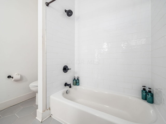 bathroom with tile patterned flooring, tiled shower / bath combo, and toilet