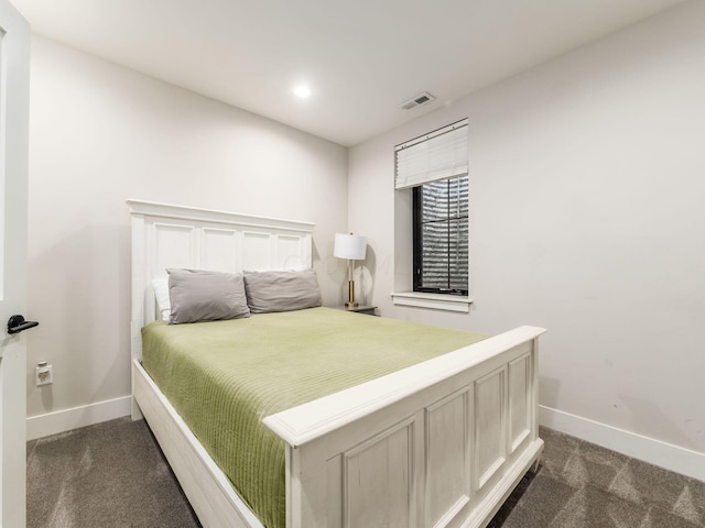 bedroom with dark colored carpet