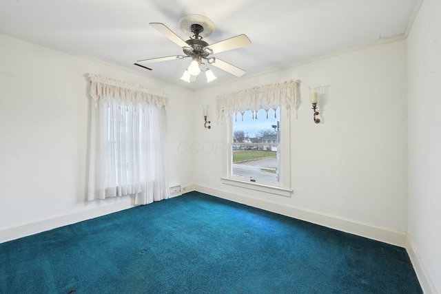 spare room with ceiling fan, carpet floors, and ornamental molding