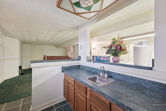 kitchen with dark tile patterned flooring and sink