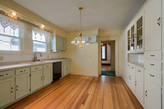 kitchen featuring black dishwasher, tasteful backsplash, light wood finished floors, and a sink