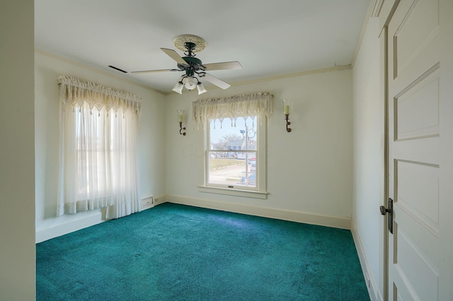 spare room featuring crown molding, a healthy amount of sunlight, baseboards, and carpet floors