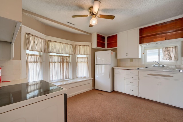 kitchen featuring decorative backsplash, white appliances, visible vents, and open shelves