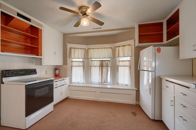 kitchen with white appliances, open shelves, light countertops, white cabinets, and light colored carpet