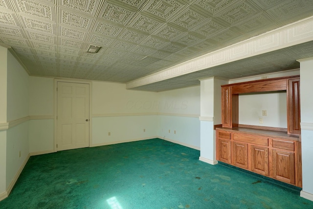 finished basement featuring carpet, baseboards, and an ornate ceiling