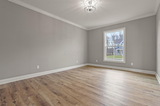 unfurnished room with crown molding, light hardwood / wood-style floors, and a textured ceiling