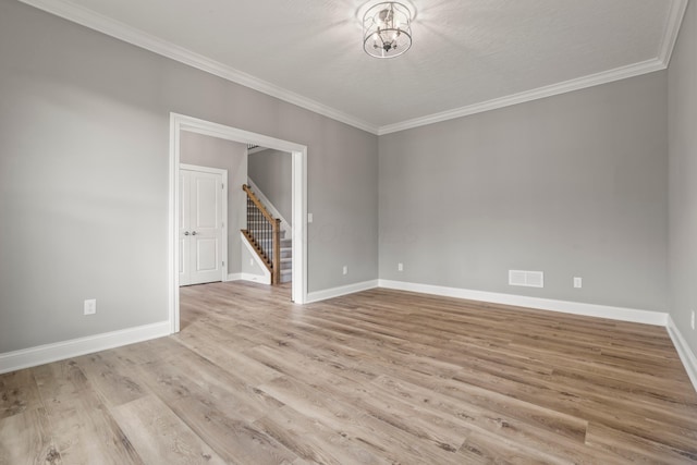 unfurnished room featuring crown molding, light hardwood / wood-style flooring, and a textured ceiling