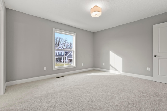 spare room featuring carpet floors