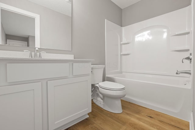 full bathroom featuring vanity, a textured ceiling, wood-type flooring, shower / tub combination, and toilet