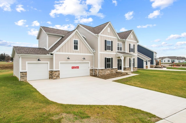 view of front of property featuring a garage and a front yard